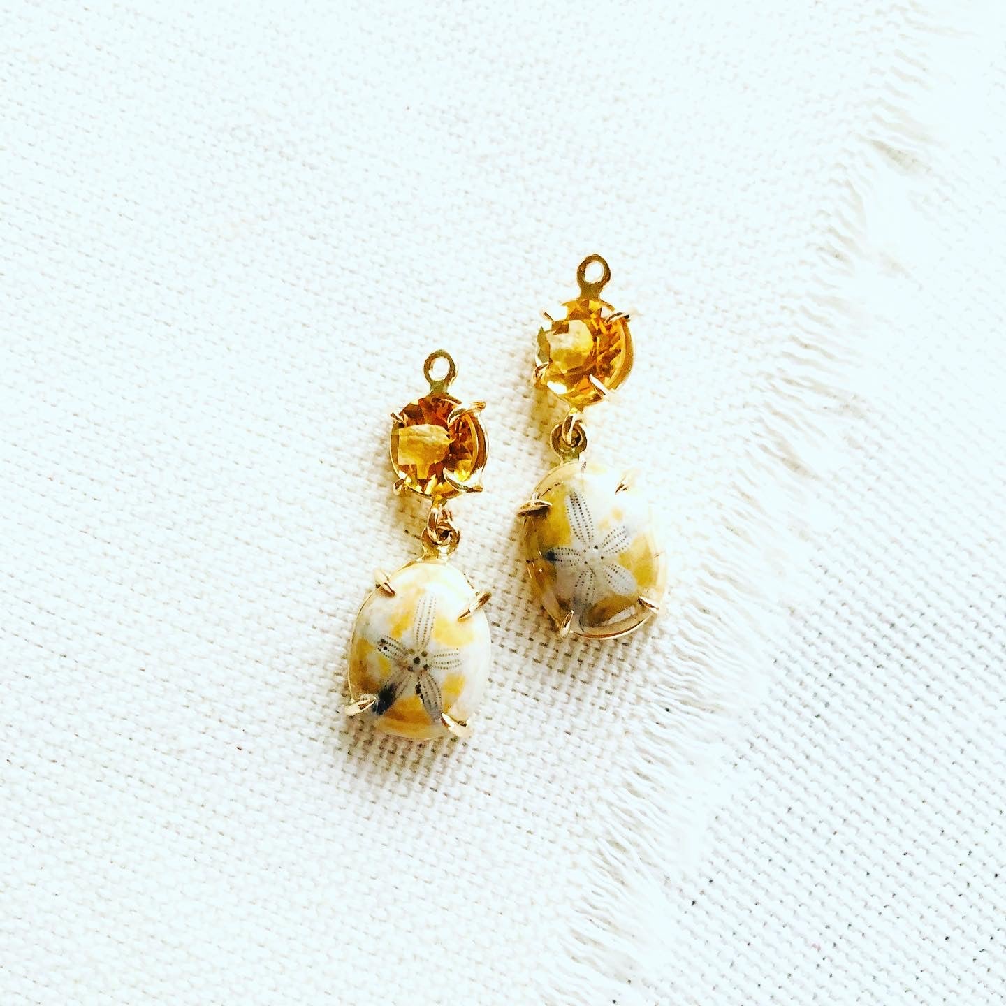 Sea urchin earrings paired with citrine and set in 14kt gold. These fossilized sea urchin earrings make a beautiful long lasting souvenir from Hawaii.