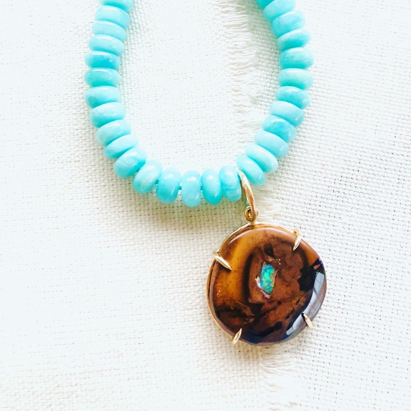 This gorgeous gold necklace is made from Yowah Nut and comes from Australian. The Yowah Nut pendant is strung on a beautiful strand of turquoise colored Amazonite beads and finished with a 14kt gold clasp.