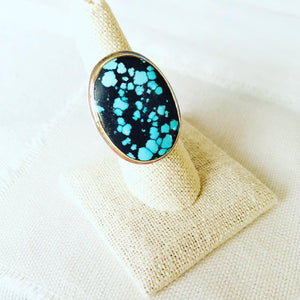 Let this turquoise statement ring compliment your resort lifestyle. The turquoise comes from Hubei and is bezel set in 14kt gold with sterling silver backplate and hand hammered shank.