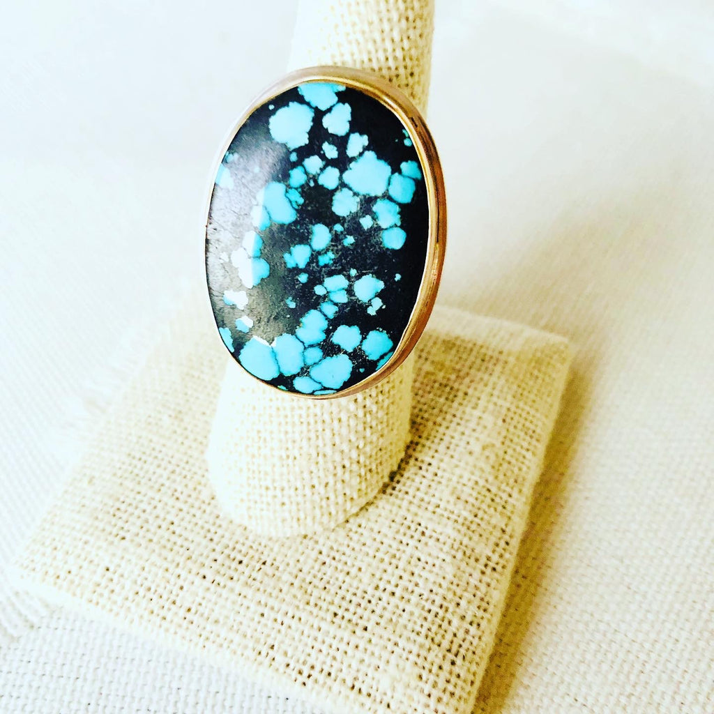 Let this turquoise statement ring compliment your resort lifestyle.  The turquoise comes from Hubei and is bezel set in 14kt gold with sterling silver backplate and hand hammered shank.