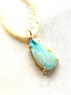 This is a beautiful blue opalized fossilized Indonesian wood pendant strung on Ethiopian Opal beads that reminds me of a confluence of rivers in snow and ice.  