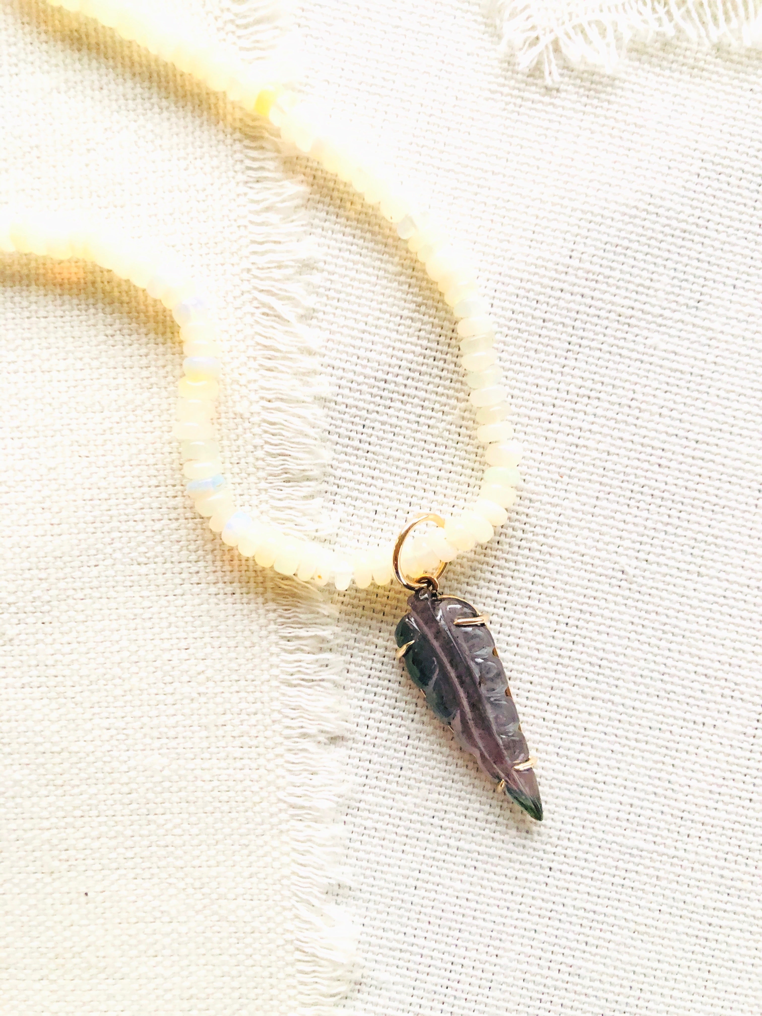 Dainty carved tourmaline leaf prong set in 14kt with a gold bail and strung over Ethiopian opal beads.  This necklace is finished with my signature 14kt gold clasp.  This carved tourmaline necklace reminds me of the beautiful large foliage we have here in Hawaii.